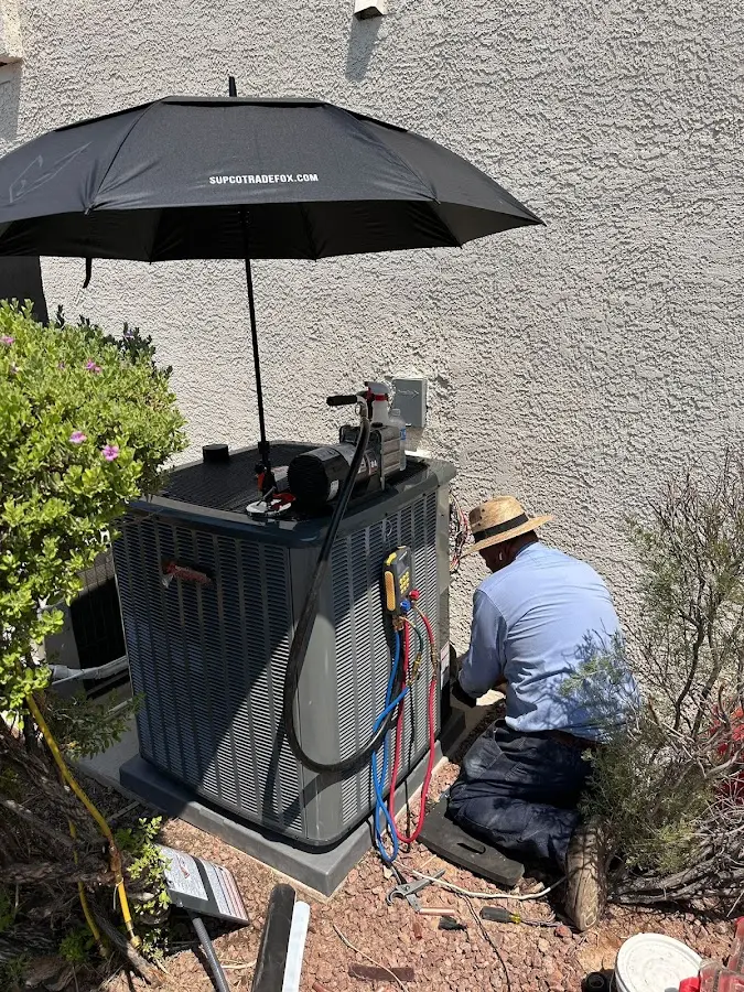 HVAC technician performing outdoor AC maintenance in White Oak